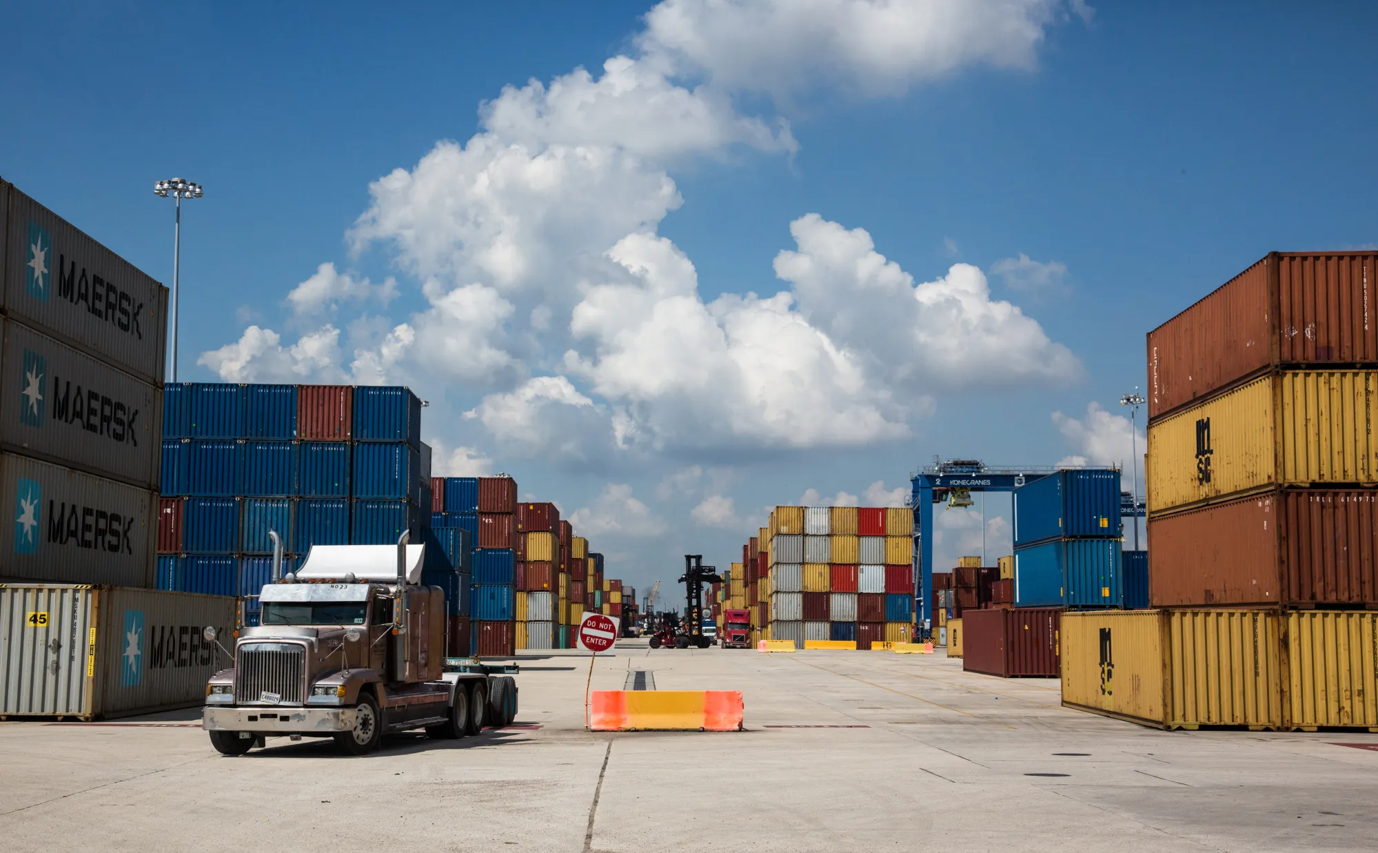 A truck drives past stacked shipping containers at the Port of New Orleans in New Orleans, Louisiana,&nbsp;on Sept. 18.&nbsp;
