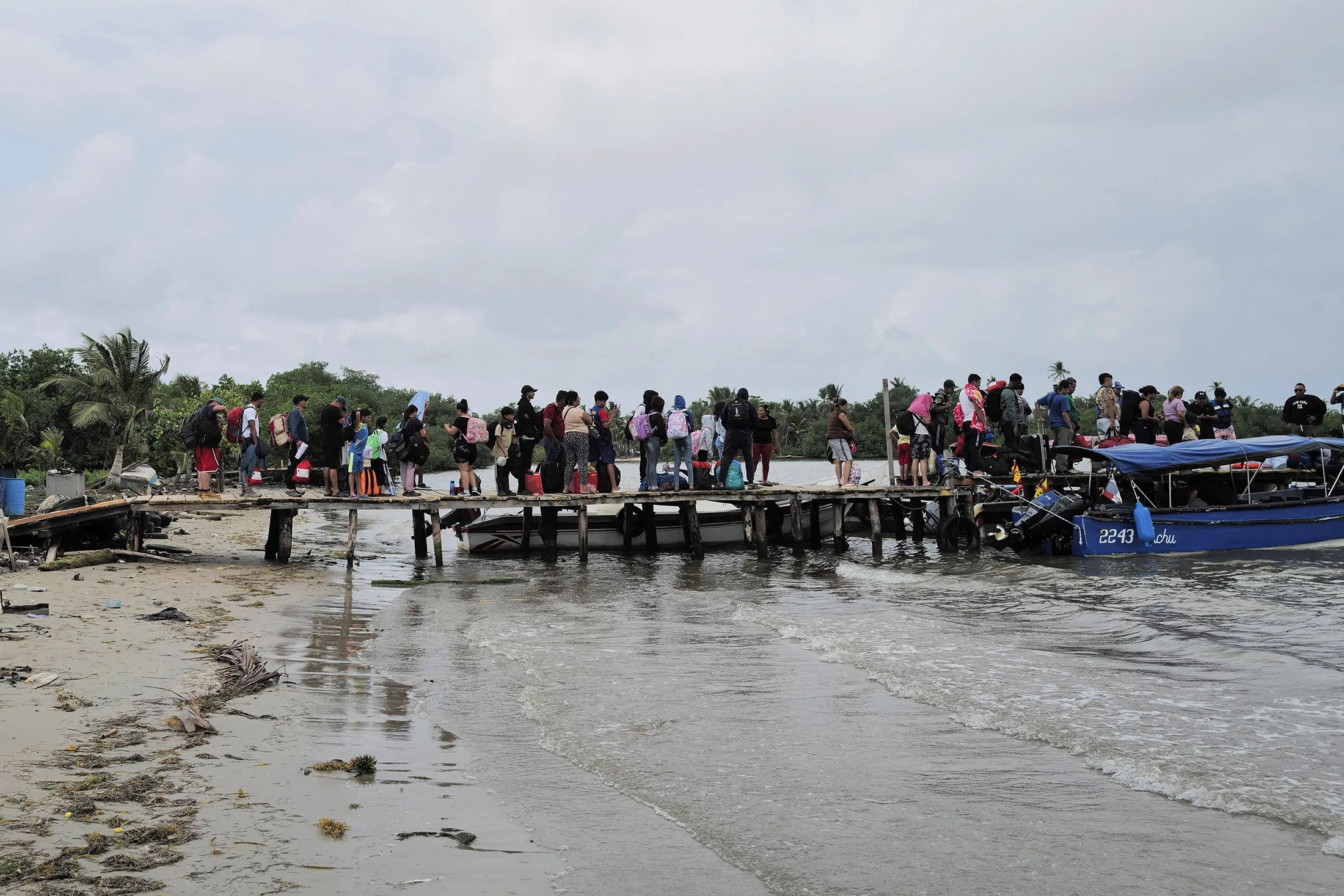 Migrants returning from the US border wait to board a boat heading to La Miel in Colombia, as they leave Port Carti in Guna Yala, Panama, on Feb. 21.