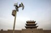A surveillance camera is mounted on a post in front of the Jiayuguan fortress, the westernmost pass of the Great Wall of China.