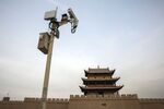A surveillance camera is mounted on a post in front of the Jiayuguan fortress, the westernmost pass of the Great Wall of China.