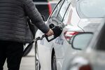 A taxi driver refuels a vehicle at a gas station in Boston, Mass.