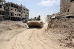 A picture taken on April 8, 2018, shows Syrian Army soldiers advancing in an area on the eastern outskirts of Douma