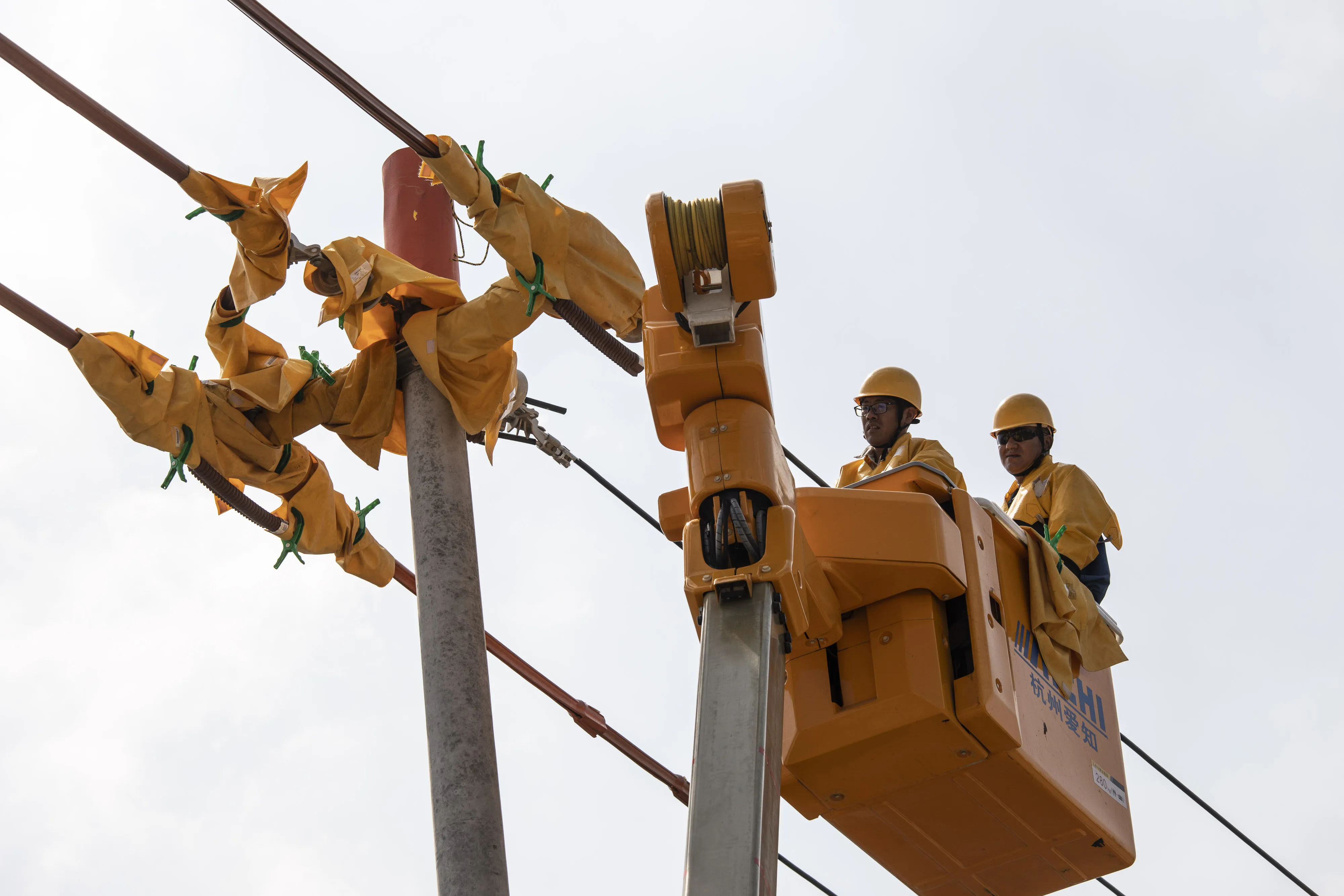 Technicians install new power lines in Wangting, Jiangsu province, China, on Thursday, Sept. 30, 2021. China's central government officials ordered the country's top state-owned energy companies -- from coal to electricity and oil -- to secure supplies for this winter at all costs, according to people familiar with the matter.