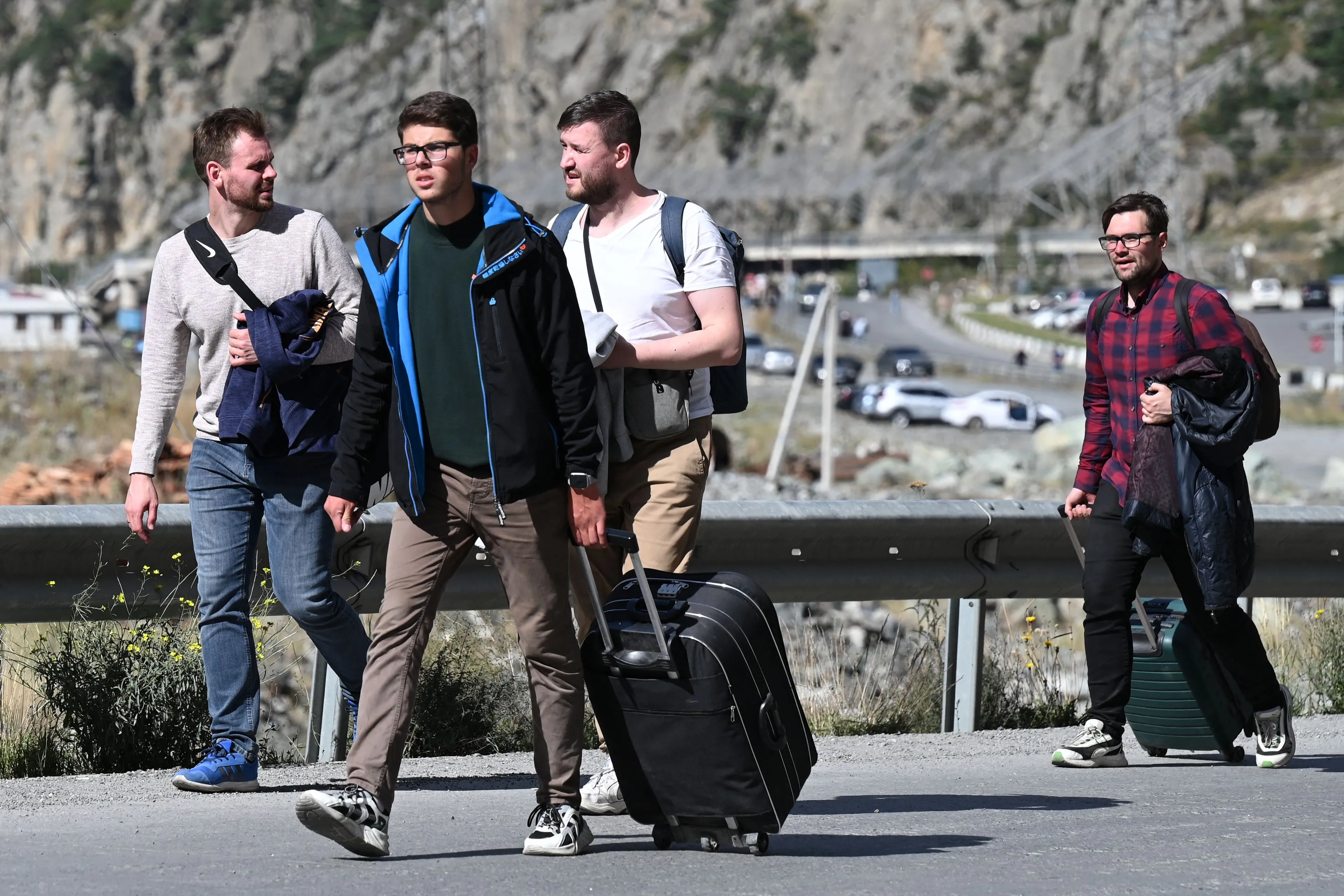 Russians arrive in Georgia after crossing the border on Wednesday.