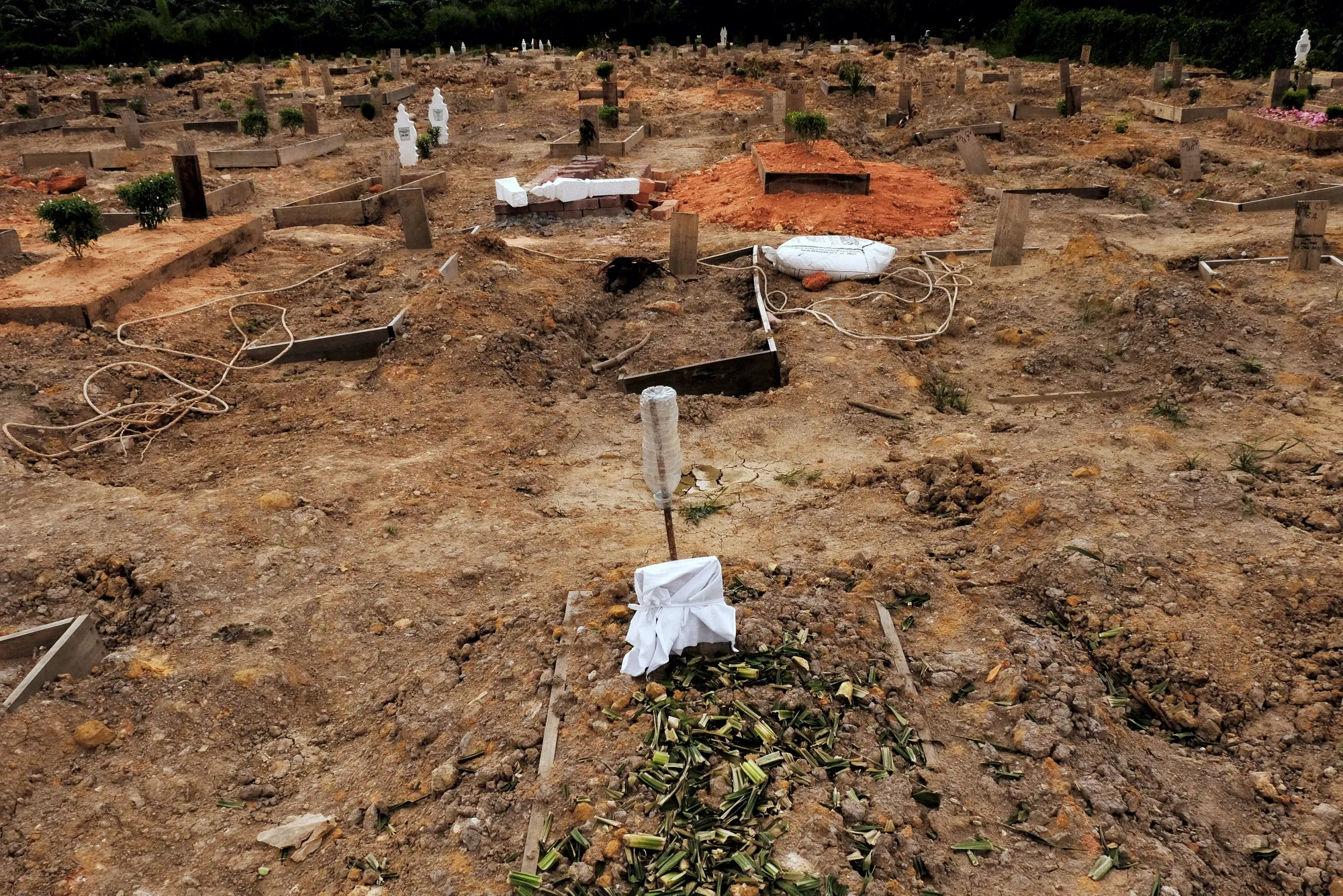 The graves of Covid-19 victims at a burial ground in Selat Klang, Malaysia, on Sept. 7. Millions more died from the coronavirus in 2021.