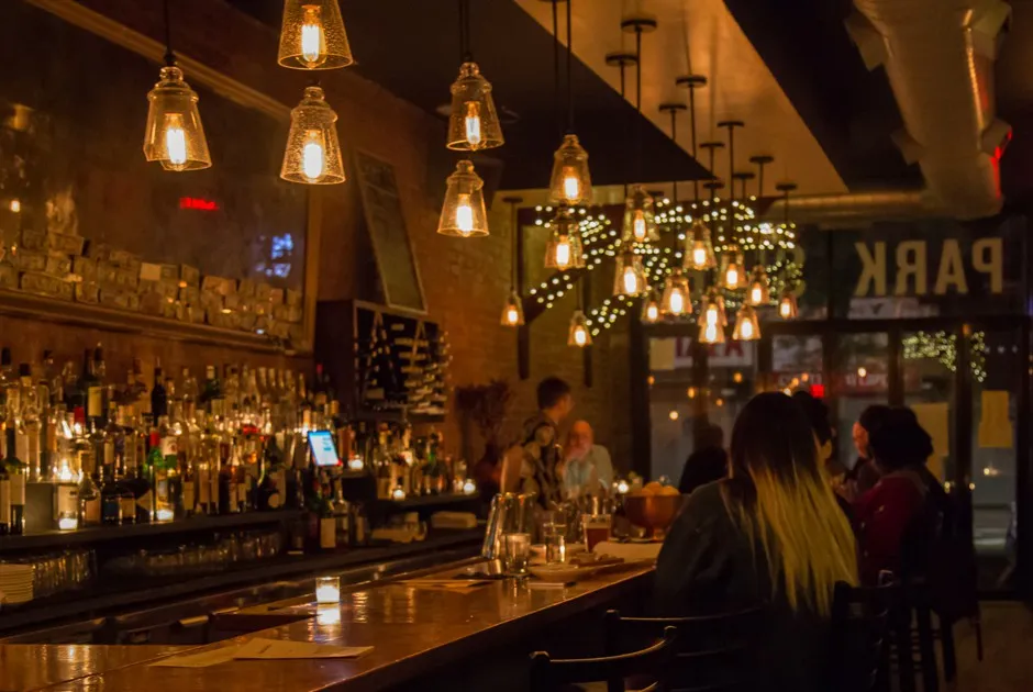 Under a tungsten sun: Brooklynites in their preferred habitat—a bar lit with Edison bulbs. 