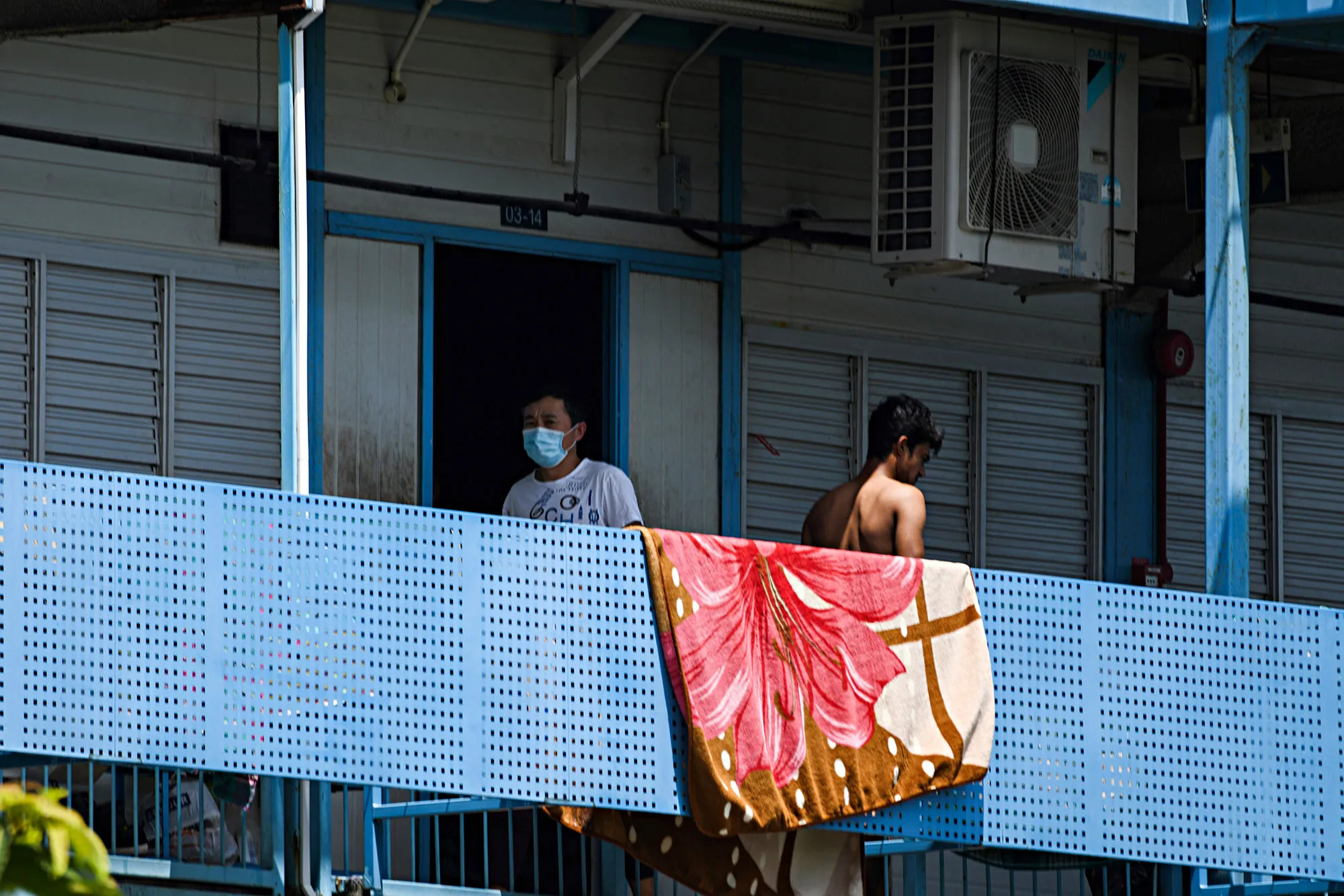 People pass on a corridor of the Tuas South foreign workers dormitory in Singapore on April 19.