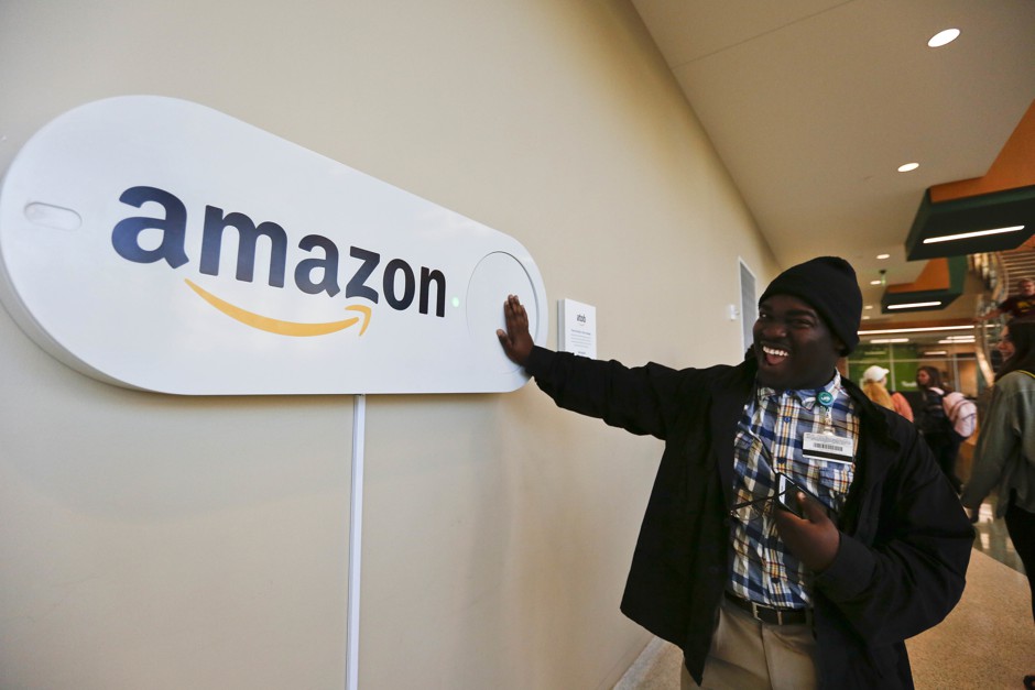 Zavian Tate, a student at the University of Alabama at Birmingham, pushes a giant Amazon Dash button, in Birmingham, Alabama, which submitted a bid for Amazon HQ2.