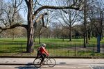 A cyclist rides past a closed Victoria Park in East London. Because of fears of crowding, several popular urban parks in the U.K. and Europe have been closed during the coronavirus crisis.