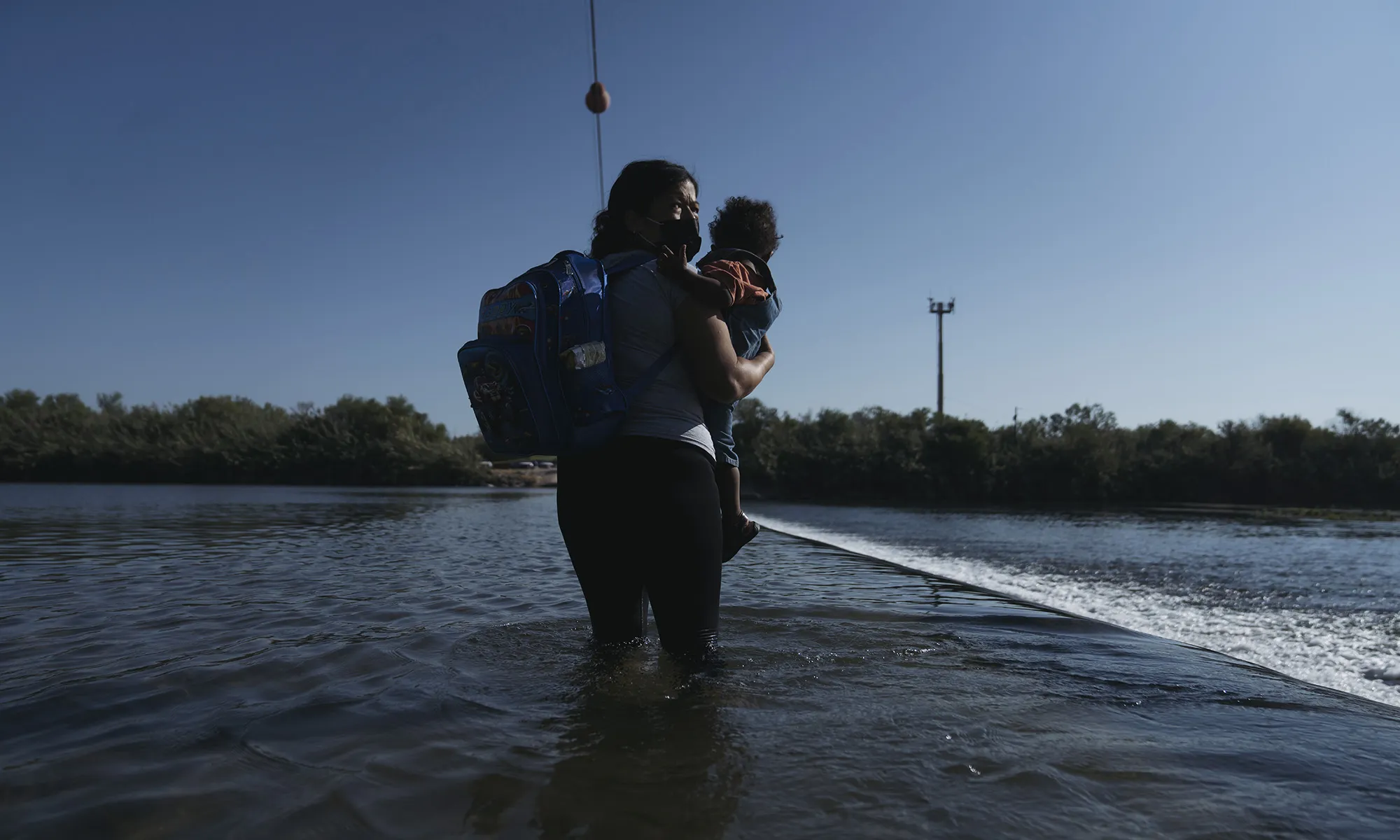 A migrant crosses the Rio Grande River near the Del Rio-Acuna Port of Entry in Ciudad Acuna, Coahuila state, Mexico, on Sept. 19.