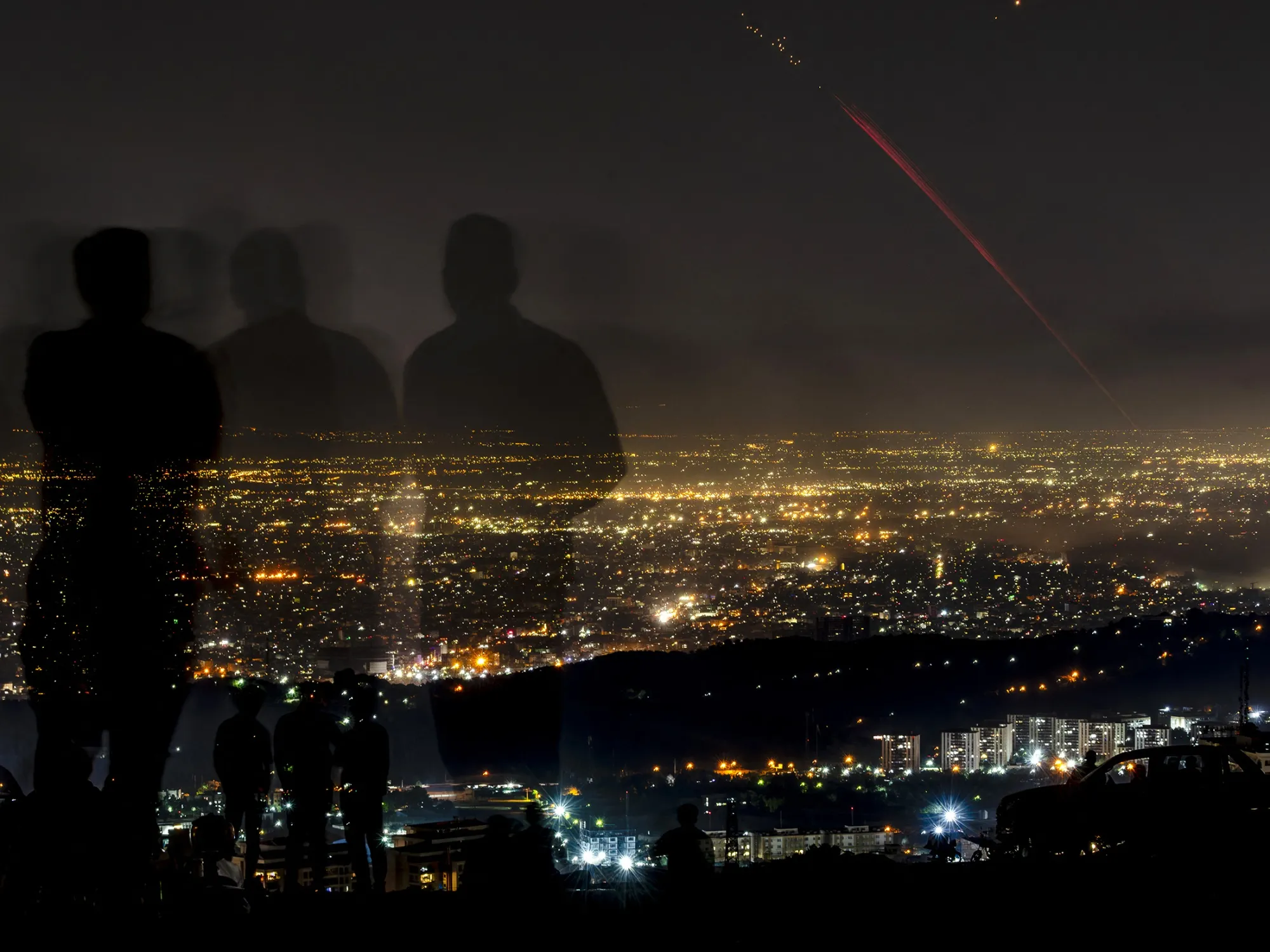 Locals watch Iran’s air defense systems and&nbsp;Israeli drones and projectiles over Tehran on&nbsp;June 15.