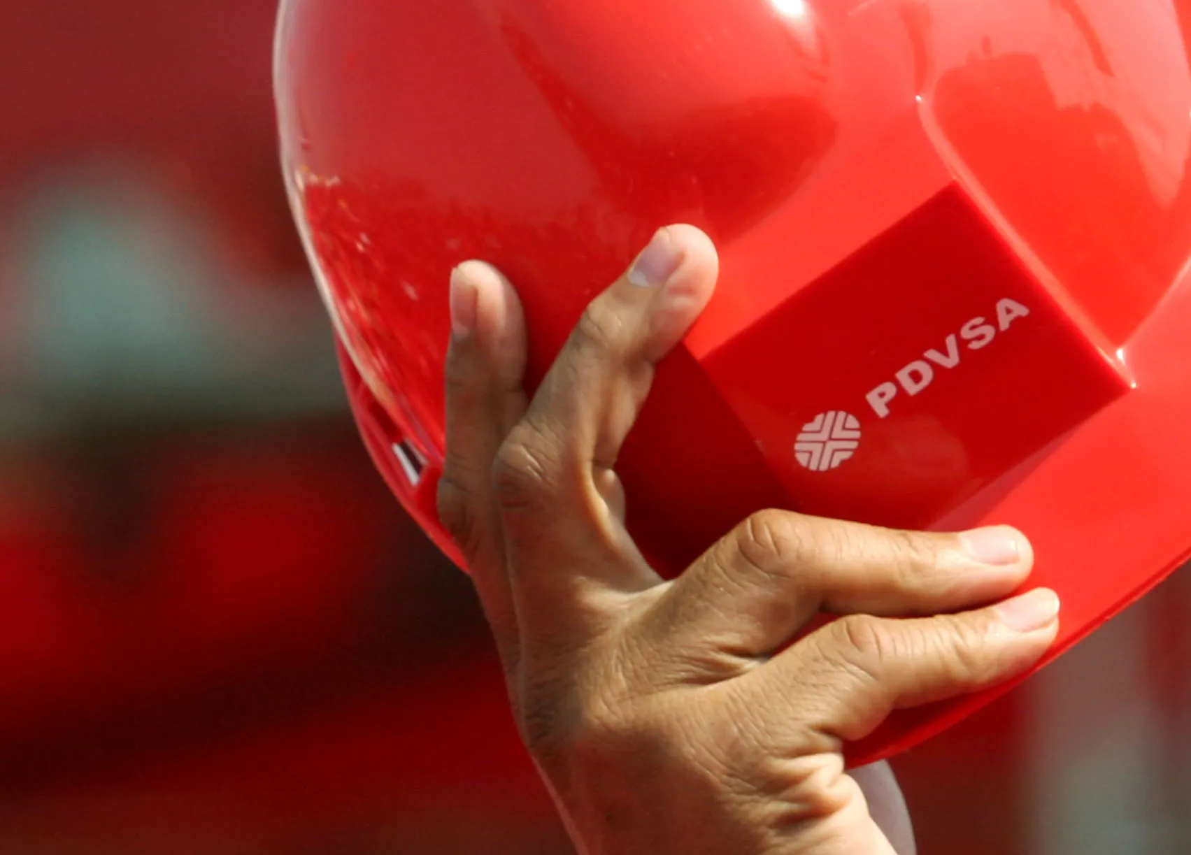 Supporter of Venezuelan President Hugo Chavez waves a helmet of PDVSA during a speach of President Chavez at the Oil Complex 'Jose Antonio Anzotegui' in Pto.La Cruz in Anzotegui state.Howard Yanes/ BLOOMBERG
