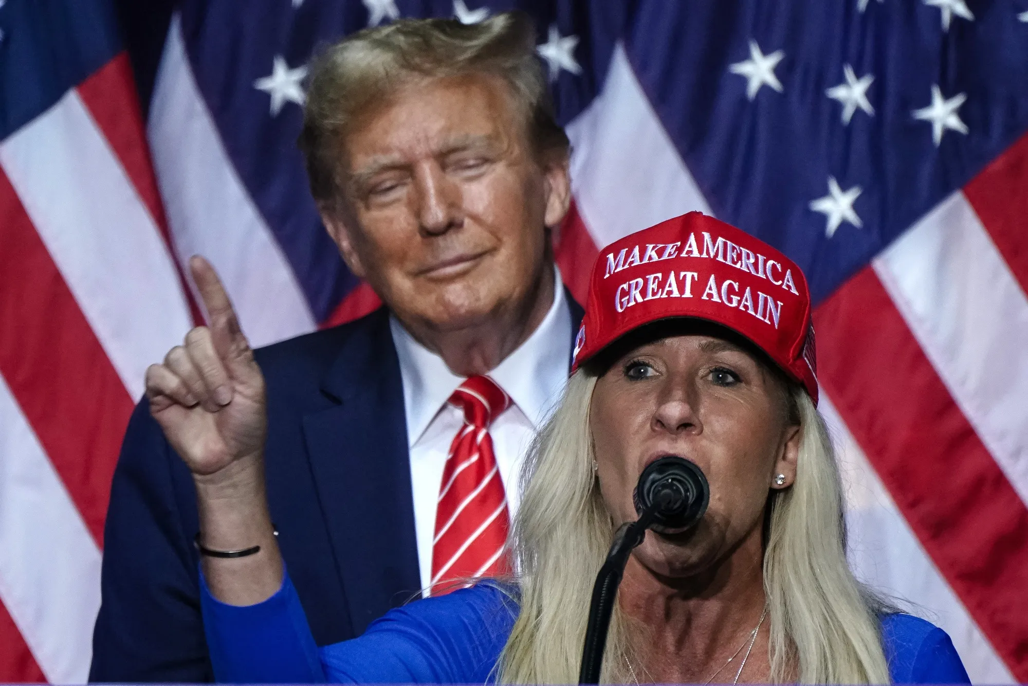 Marjorie Taylor Greene, right, speaks alongside President Donald Trump in 2024.