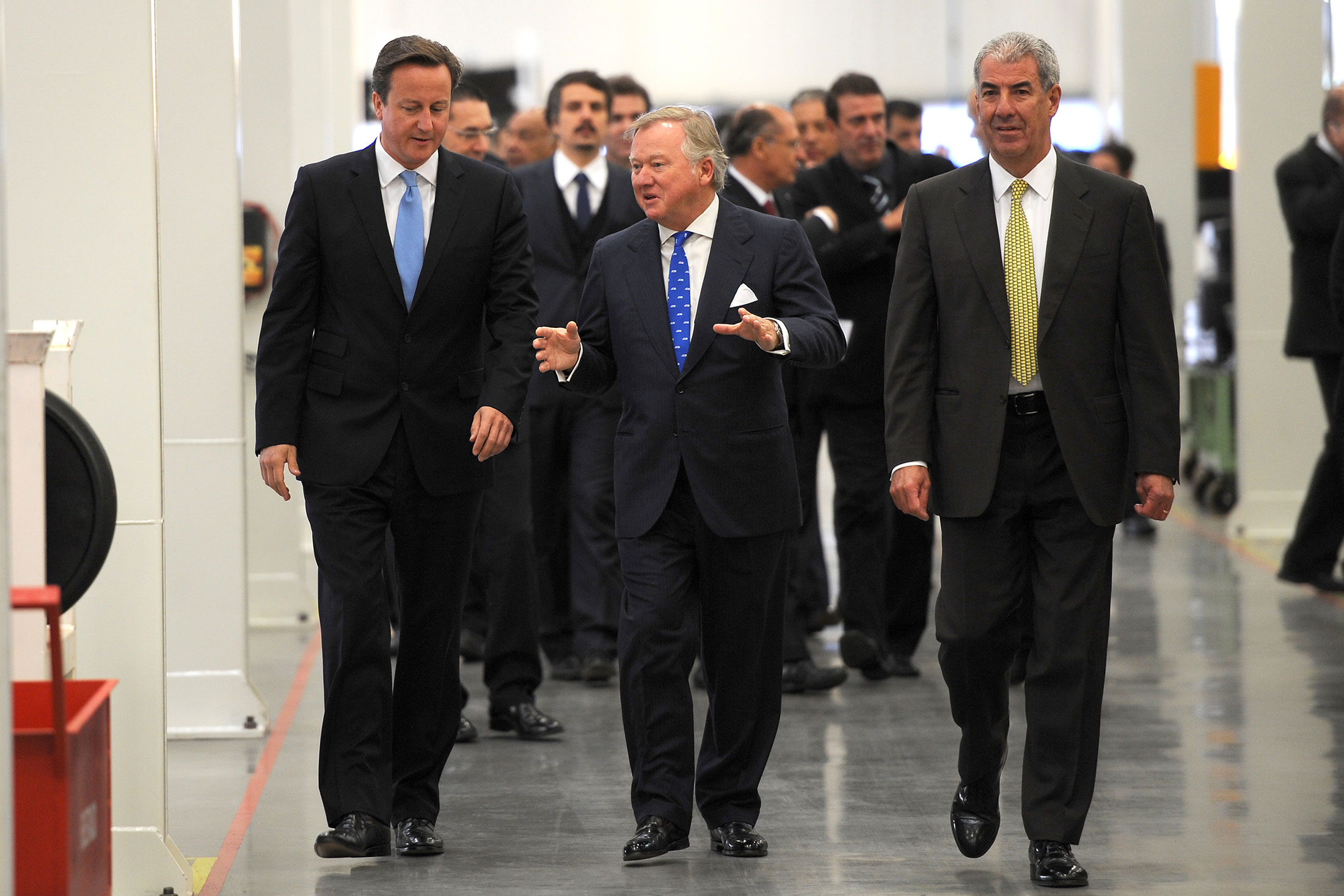 Anthony Bamford, center, tours a tours a JCB factory in Sao Paulo with former U.K. prime minister David Cameron, left.