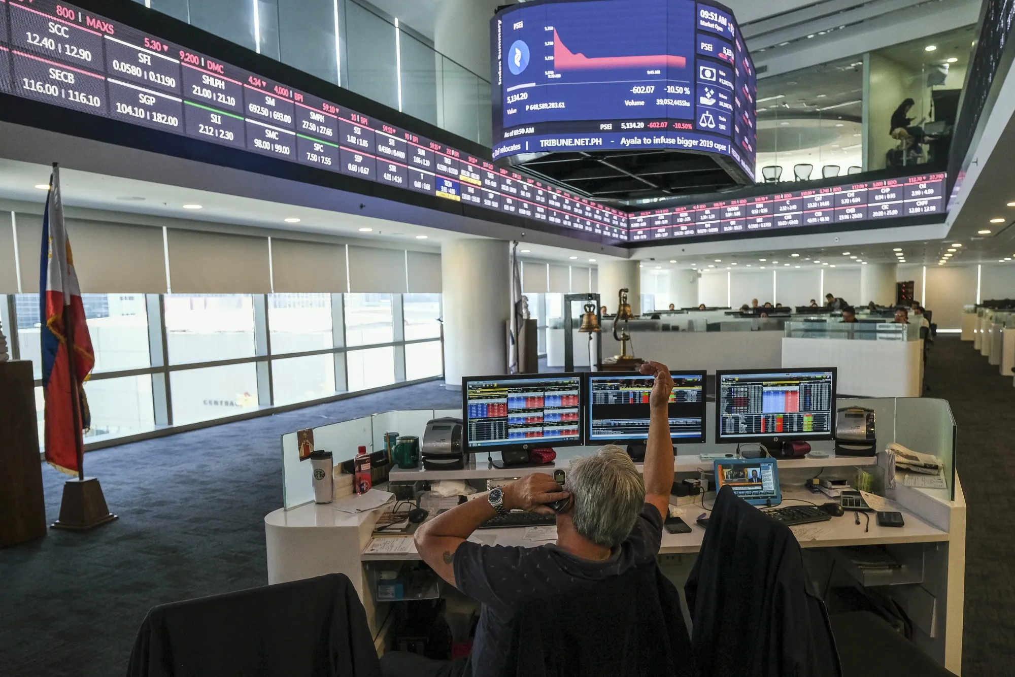 A trader uses a telephone on the trading floor of the Philippine Stock Exchange.