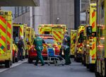 Paramedics take a wheelchair from an ambulance outside the Royal London Hospital in London, UK.