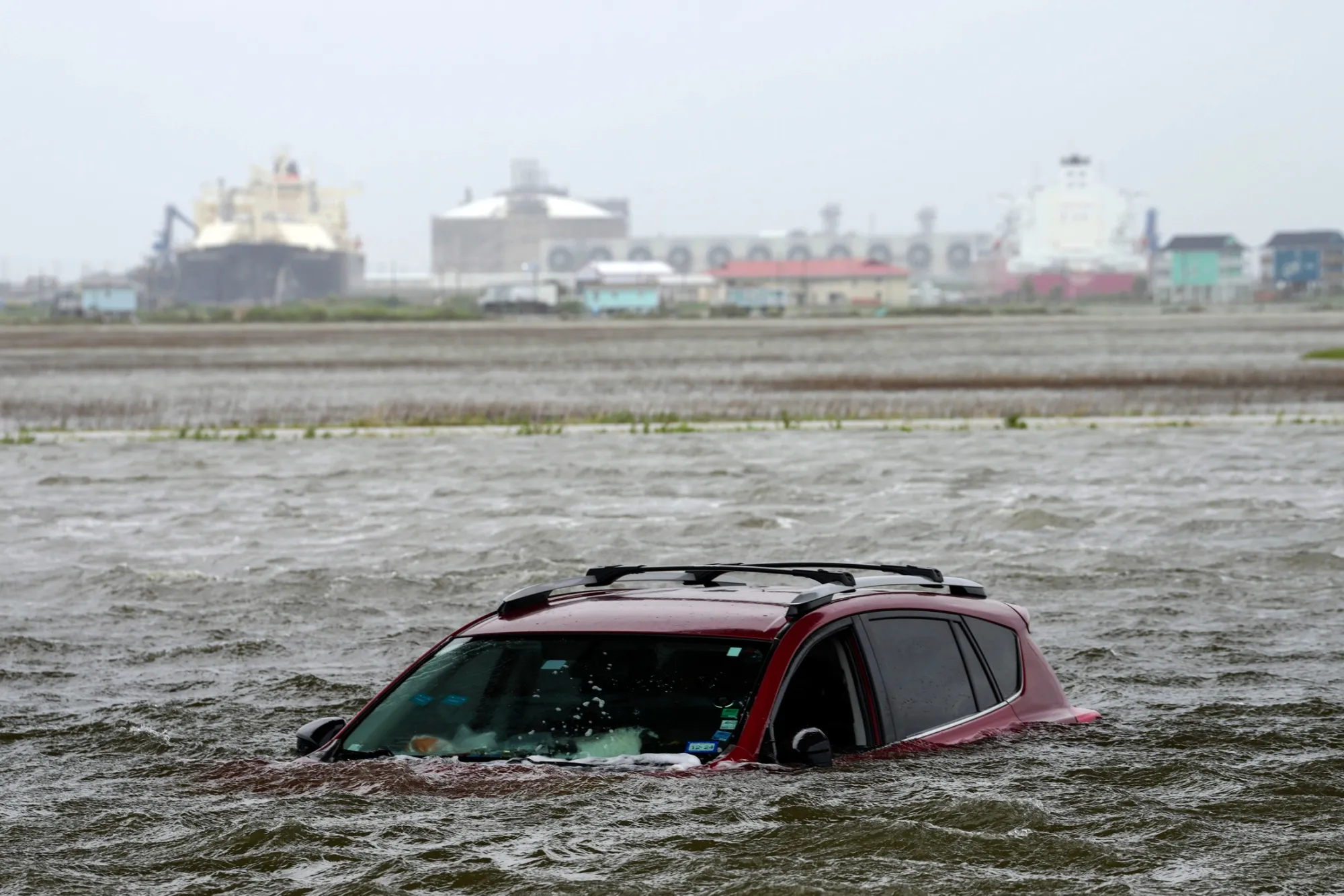 A car sits submerged in water in Surfside Beach, Texas, on June 19 as Tropical Storm Alberto approaches land.