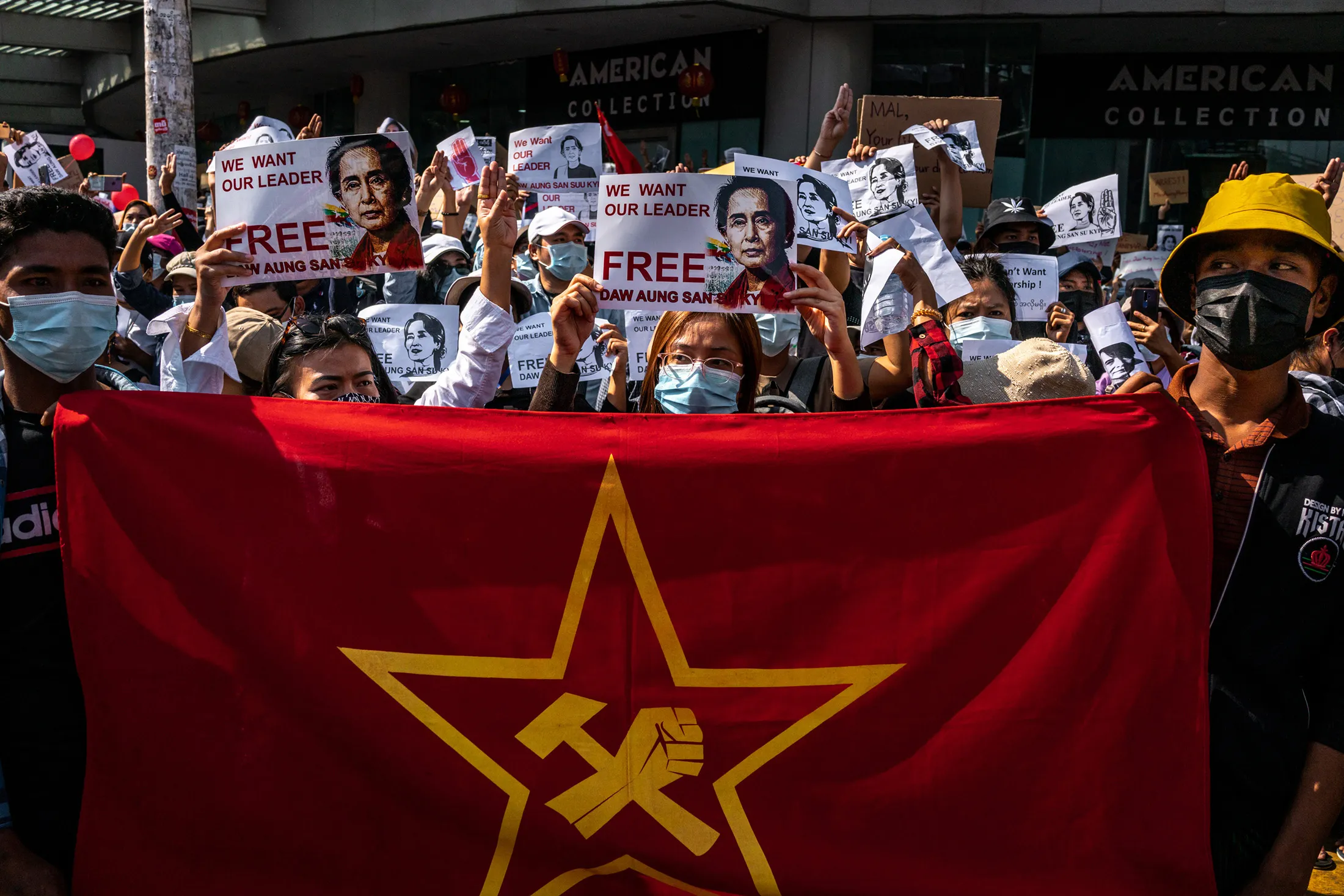 Protesters hold photos of Aung San Suu Kyi during a protest in Yangon, on Feb 9.