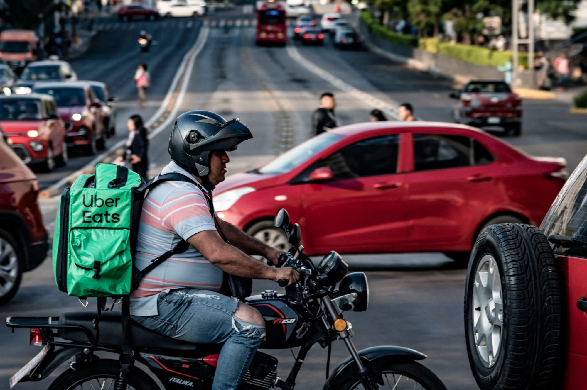 A delivery worker carries an Uber Eats bag in Mexico City.