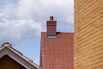 A Chimney On The Rooftop Of A Residential Building