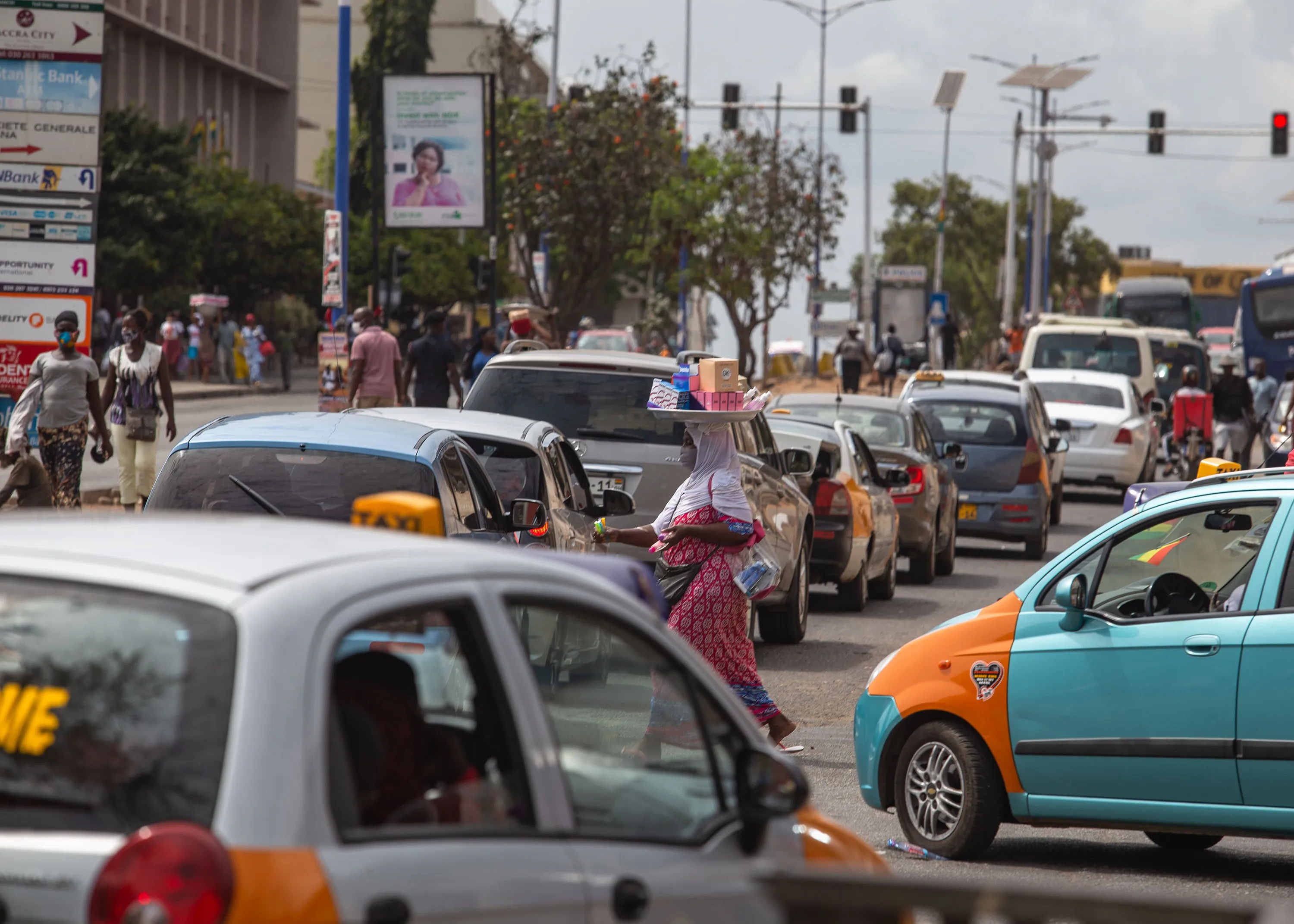 A woman sells goods in traffic&nbsp;in Accra, Ghana.