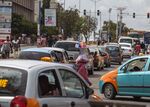 A woman sells goods in traffic in Accra, Ghana.