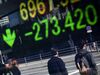 Pedestrians are reflected in an electronic stock board outside a securities firm in Tokyo, Japan.