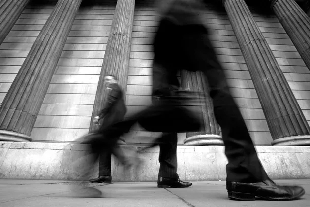 Pedestrians pass the Bank of England in London