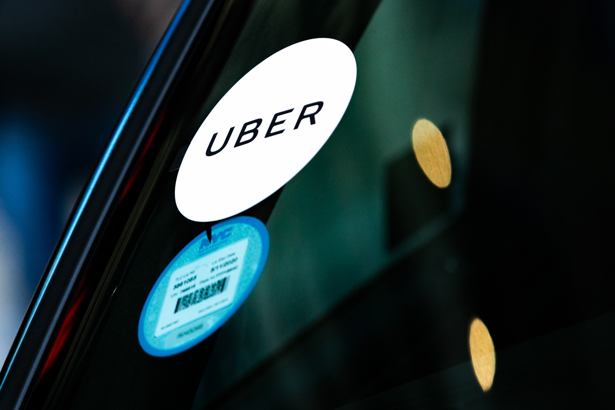 An Uber sticker is displayed on a vehicle in New York.
