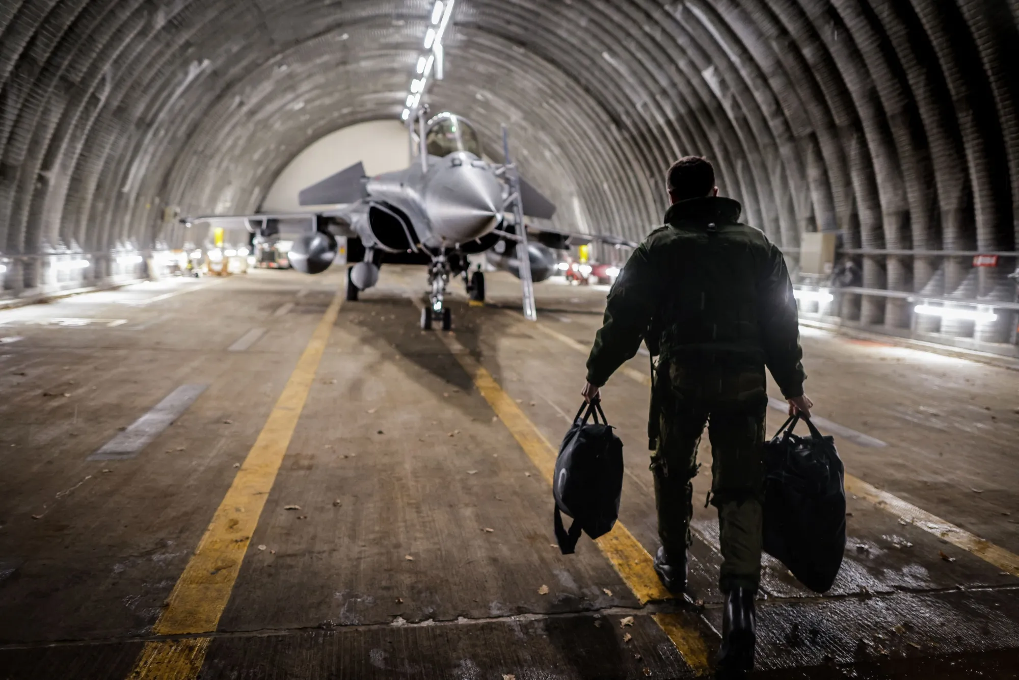 A jet fighter pilot prepares his aircraft before leaving.&nbsp;