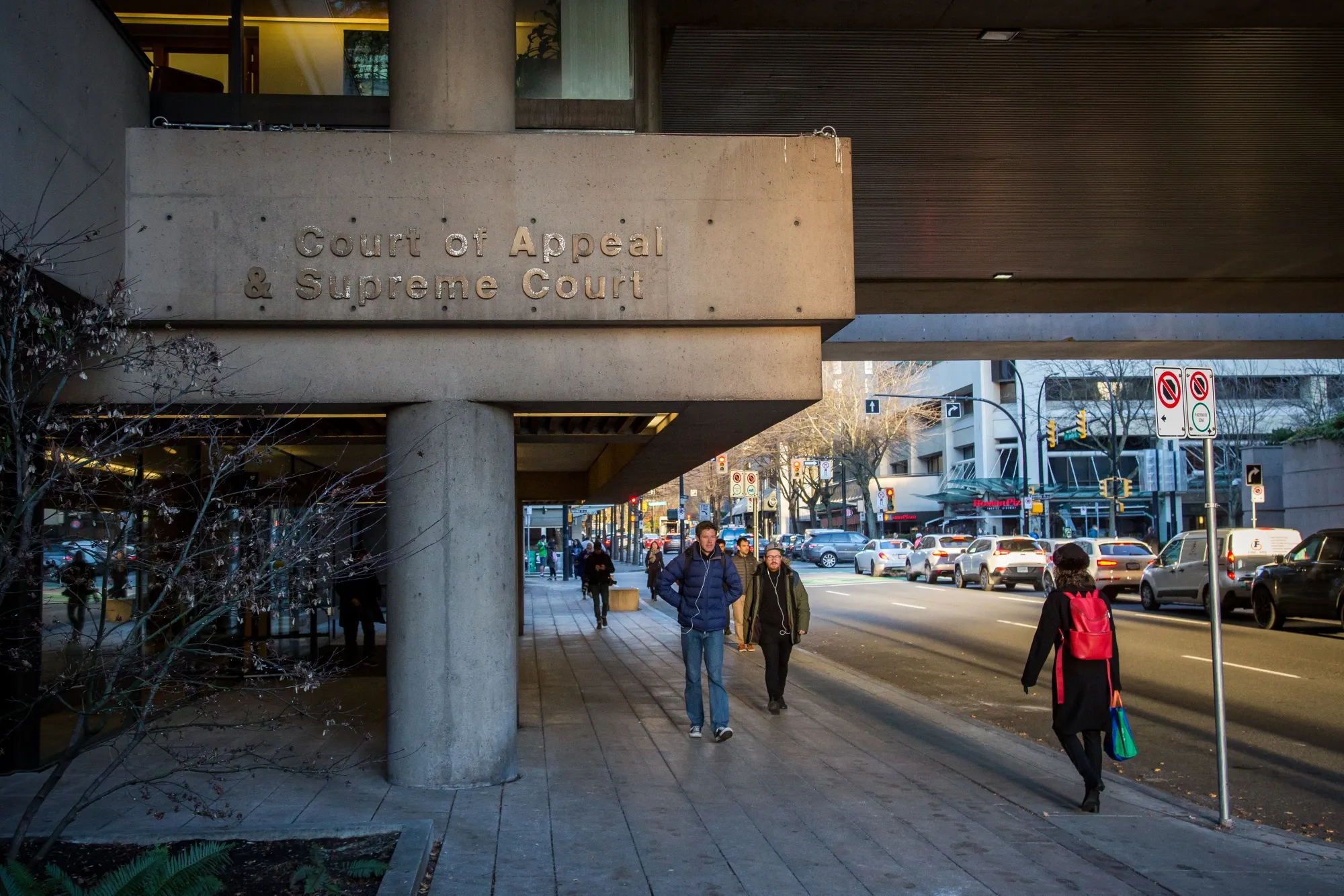 Pedestrians walk past the Supreme Court in Vancouver on&nbsp;Dec. 7.