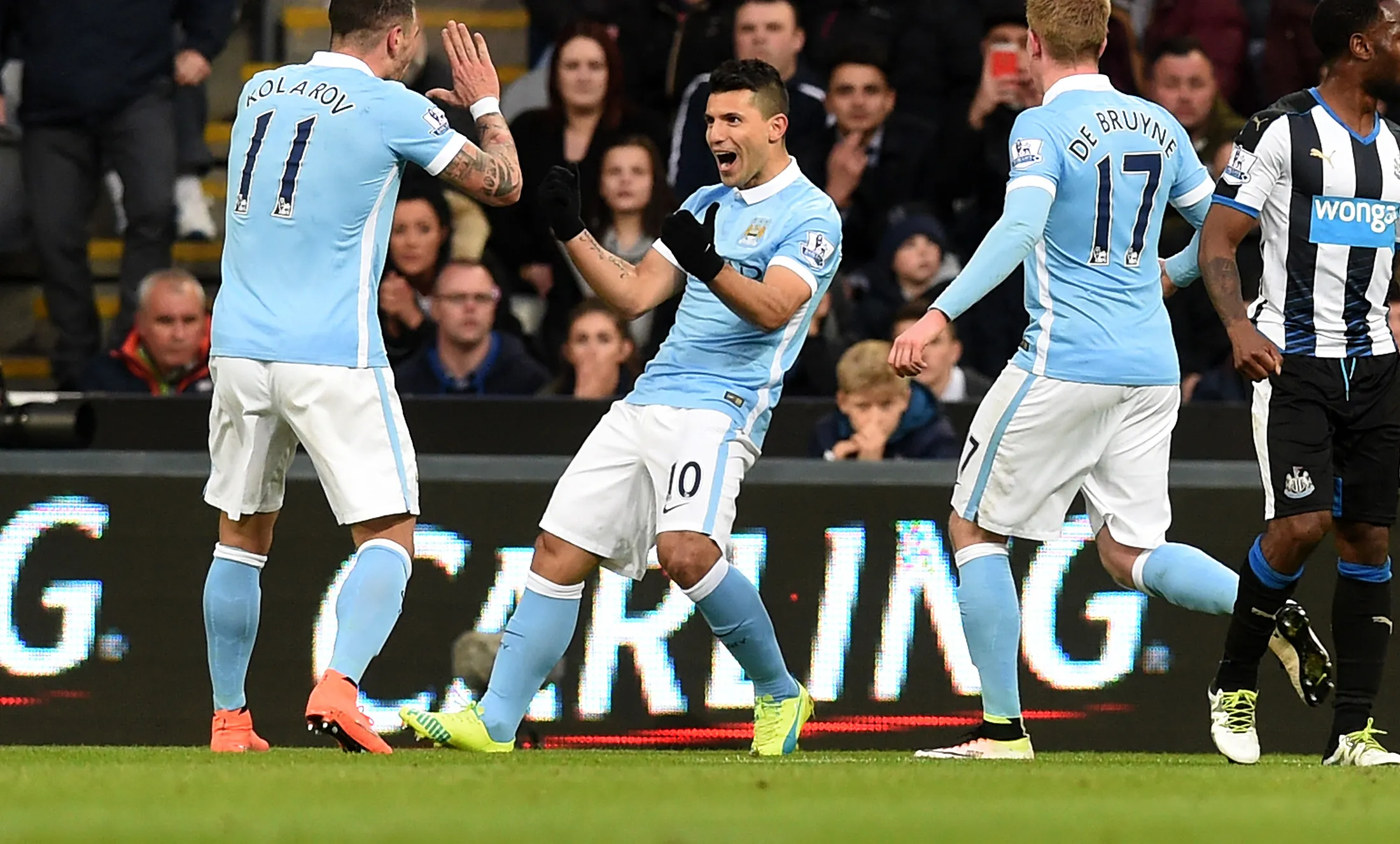 Sergio Aguero, center, of Manchester City is congratulated by teammates after scoring the opening goal with a header during the Barclays Premier League match between Newcastle United and Manchester City at St James' Park on April 19, 2016 in Newcastle, England.
