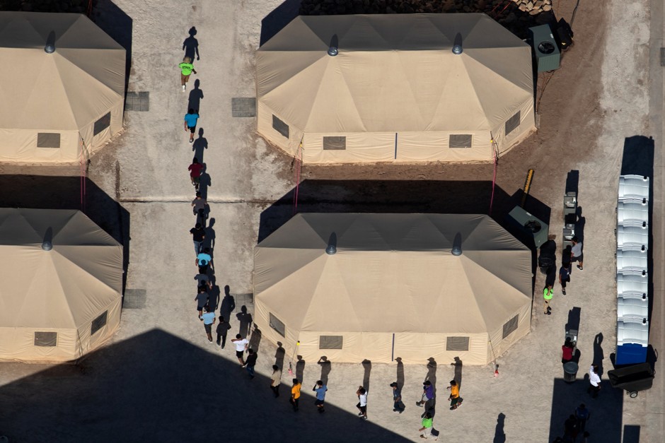 Immigrant children are led by staff in single file between tents at a detention facility next to the Mexican border in Tornillo, Texas, on June 18.