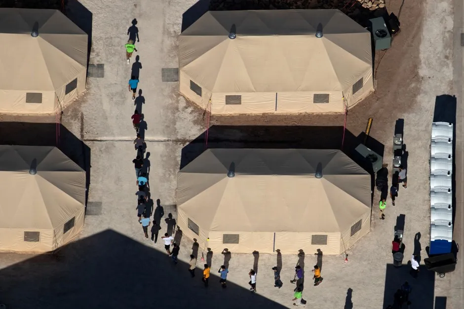 Immigrant children are led by staff in single file between tents at a detention facility next to the Mexican border in Tornillo, Texas, on June 18.
