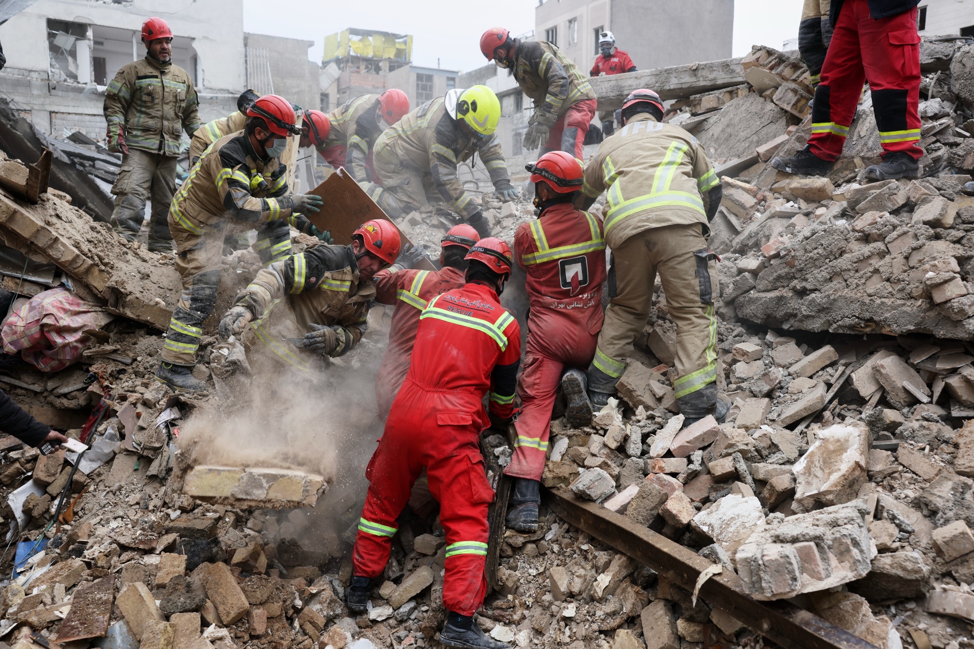 Rescue workers search for survivors in the rubble following&nbsp;an airstrike in Tehran on March 13.&nbsp;