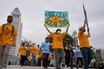 Demonstrators hold up placards in front of Los Angeles City Hall during a Save Our Solar Jobs rally hosted by the California Solar &amp; Storage Association in Los Angeles, California, on&nbsp;Jan. 13, 2022.