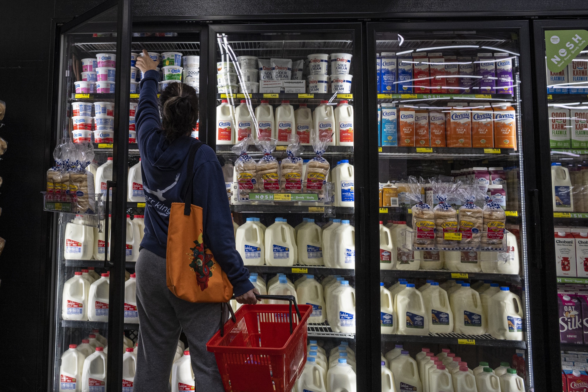 A shopper reaches inside a grocery store in San Francisco.&nbsp;