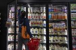A shopper reaches inside a grocery store in San Francisco. 