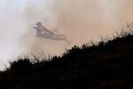 A firefighting airplane flies over a wildfire near Alcublas, eastern Spain, on Thursday, Aug. 18, 2022. The European Forest Fire Information System says 275,000 hectares (679,000 acres) have burned in wildfires so far this year in Spain. That's more than four times the country's annual average of 67,000 hectares (165,000 acres) since 2006, when records began. (AP Photo/Alberto Saiz)