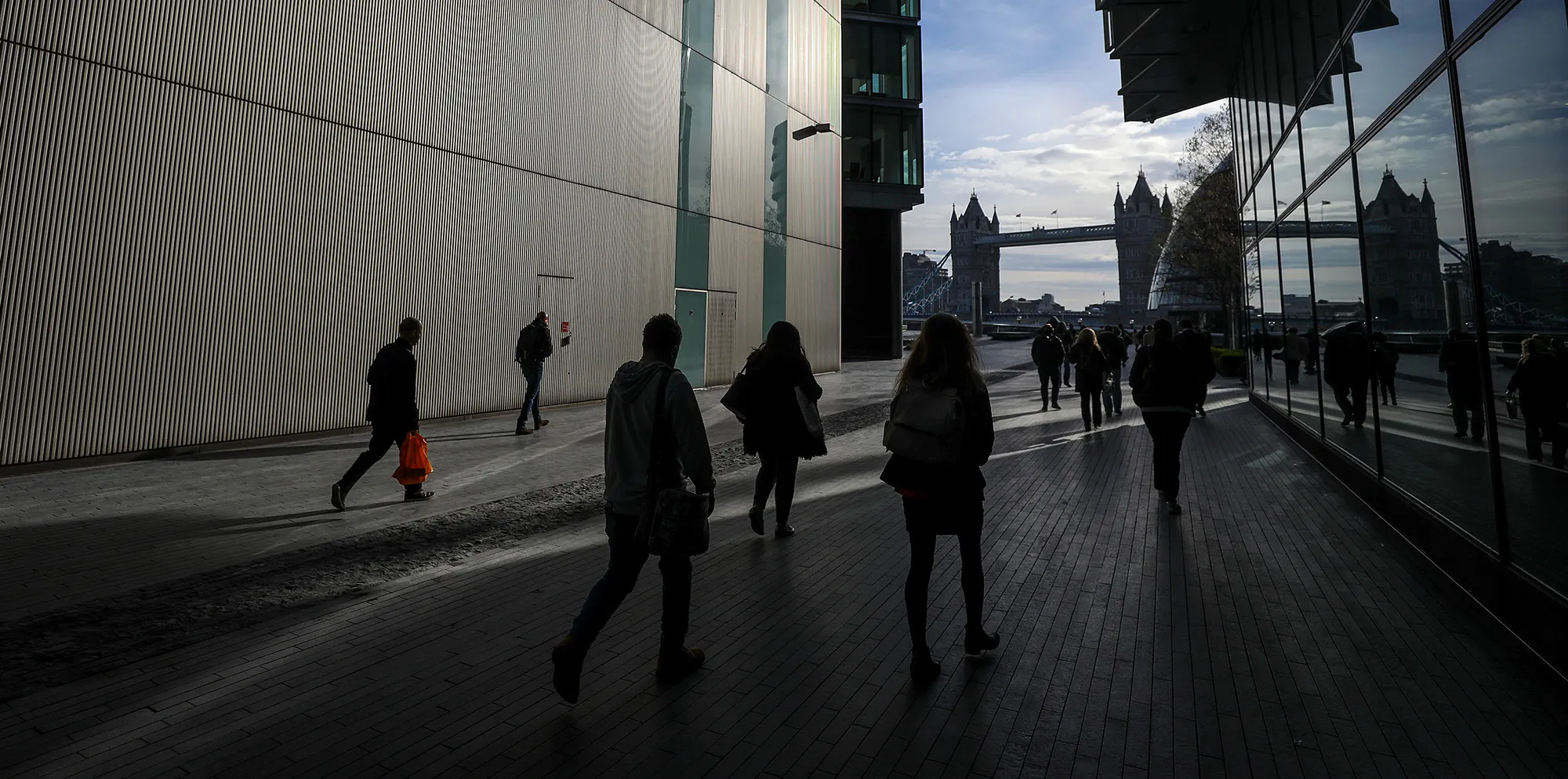 Pedestrians walk through More London Retail and office development in London.