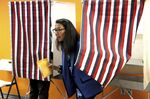 Mary Peltola leaves a voting booth while early voting, on Aug. 12.