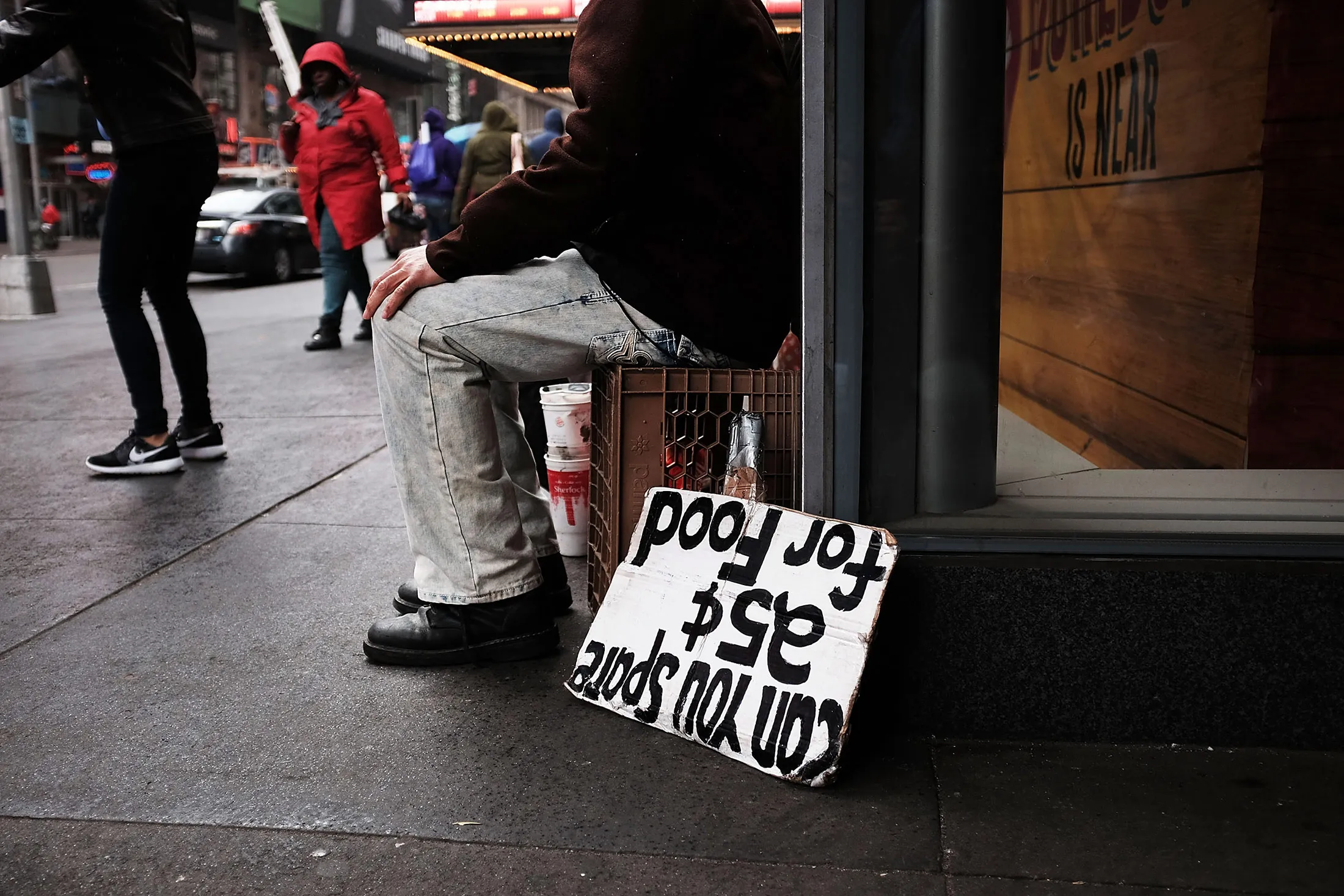 A man panhandles for money and food on April 7, in New York City.
