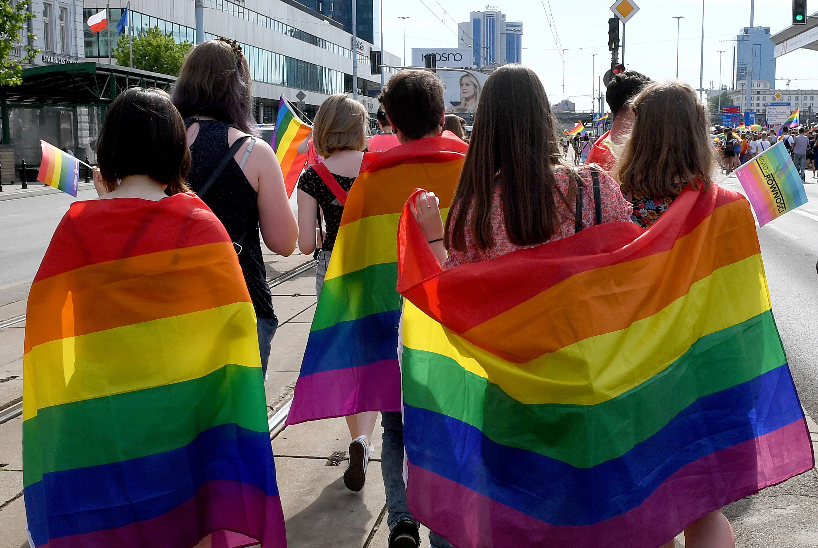 Participants of a gay pride parade walk through the streets of Warsaw on June 9, 2018.