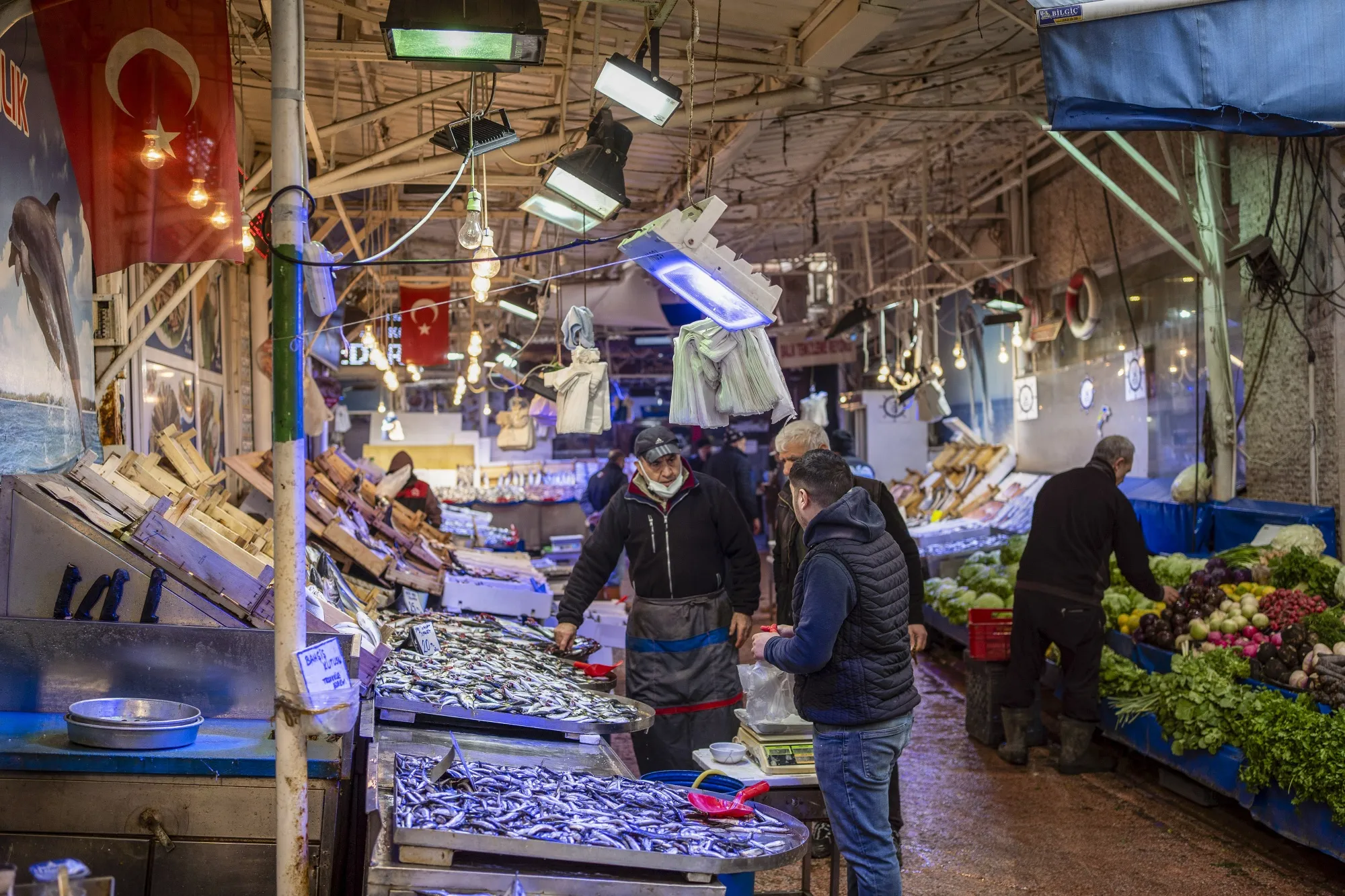 A vendor serves a customer in a local market in Bursa, Turkey,