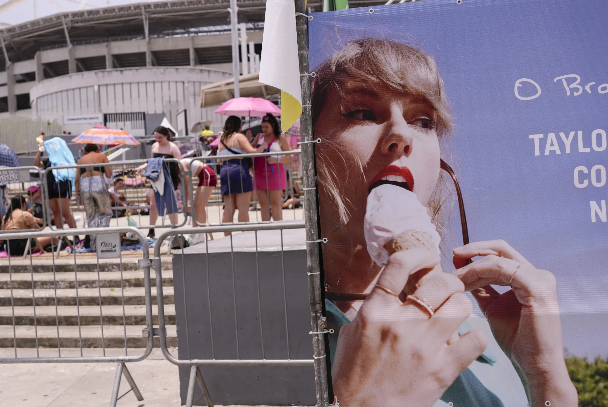 Taylor Swift fans shelter from the sun outside the Nilton Santos stadium&nbsp;in Rio De Janeiro on Nov. 18.