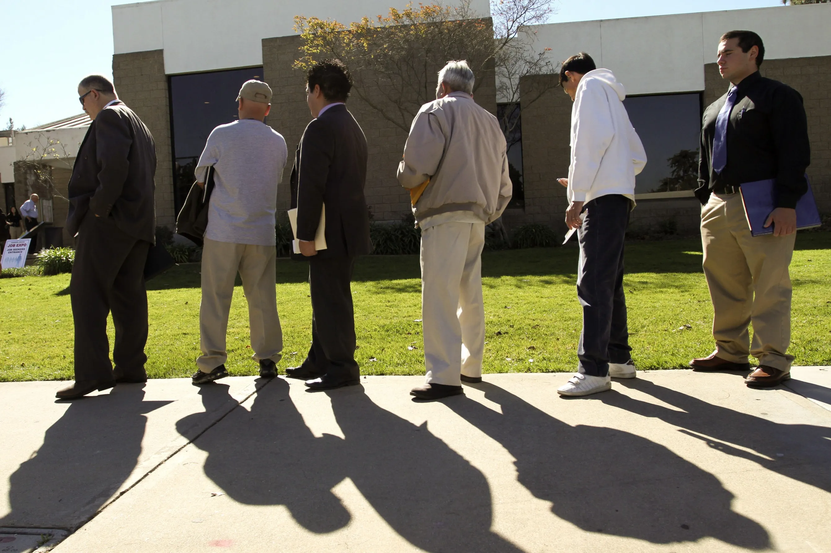 Job seekers wait in line to enter a job fair in Garden Grove, California.