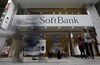 Pedestrians walk past a SoftBank Group Corp. store in Tokyo.
