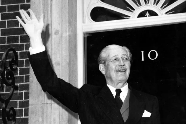 British Prime Minister Harold Macmillan waves at the door of No. 10, Downing St., on Oct. 8, 1963