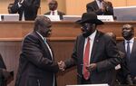 Riek Machar and Salva Kiir shake hands in Addis Ababa on Sept. 12, 2018.