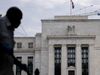 A National Parks Service worker walks past the Marriner S. Eccles Federal Reserve building in Washington, D.C., U.S., on Wednesday, July 31, 2019. The Federal Reserve is widely expected to lower interest rates by a quarter-point at its meeting that concludes Wednesday and leave the option open for additional moves despite demands by President Donald Trump for a "large" rate cut.